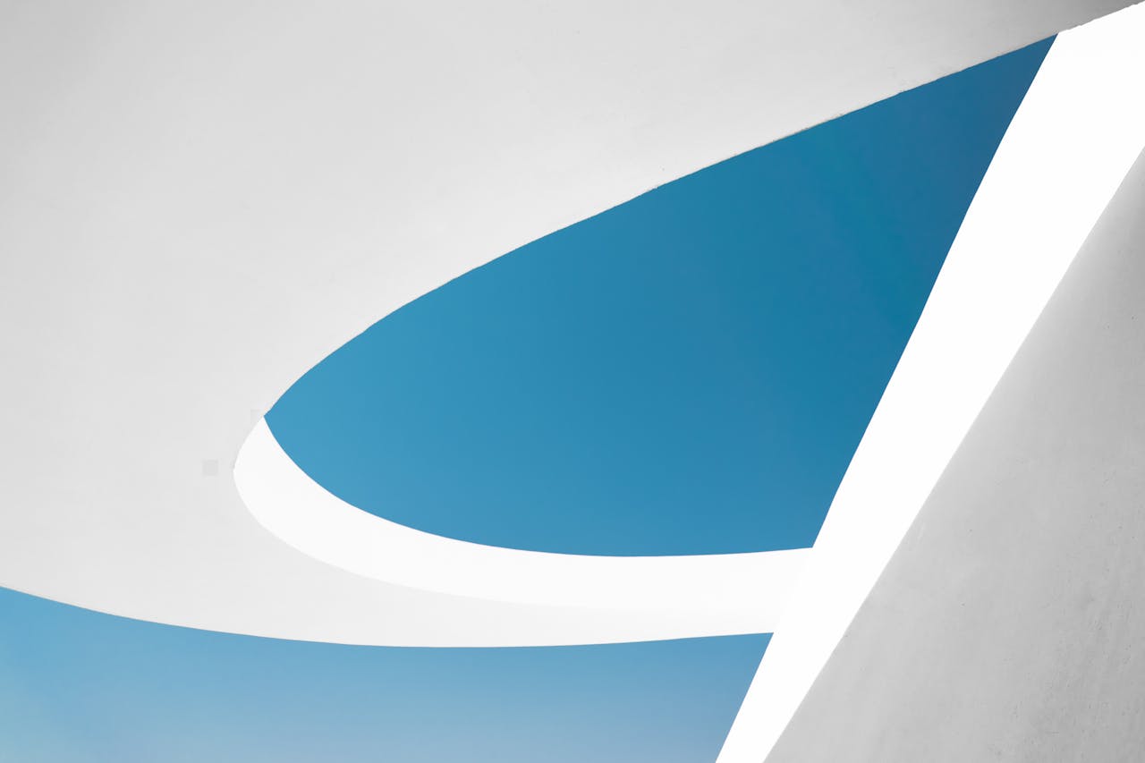 An abstract view of modern architecture against a clear blue sky in Brasília, Brazil.